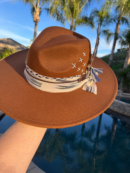 Brown Felt Fedora Hat with Handcrafted Western Elegance has a blue band  crisscross stitch  along with a beautiful band and feathers